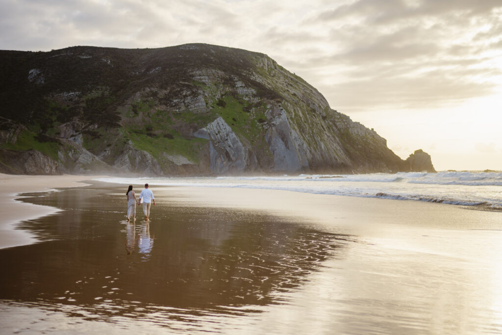 A couple holding hands at the beach