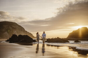 A couple holding hands at the beach