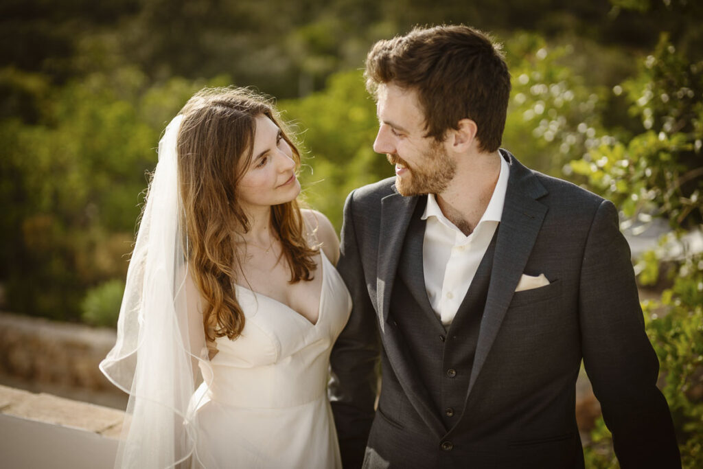 Bride and groom smiling look at each other in Loule, Portugal