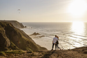 Couple embracing on cliff near the beach