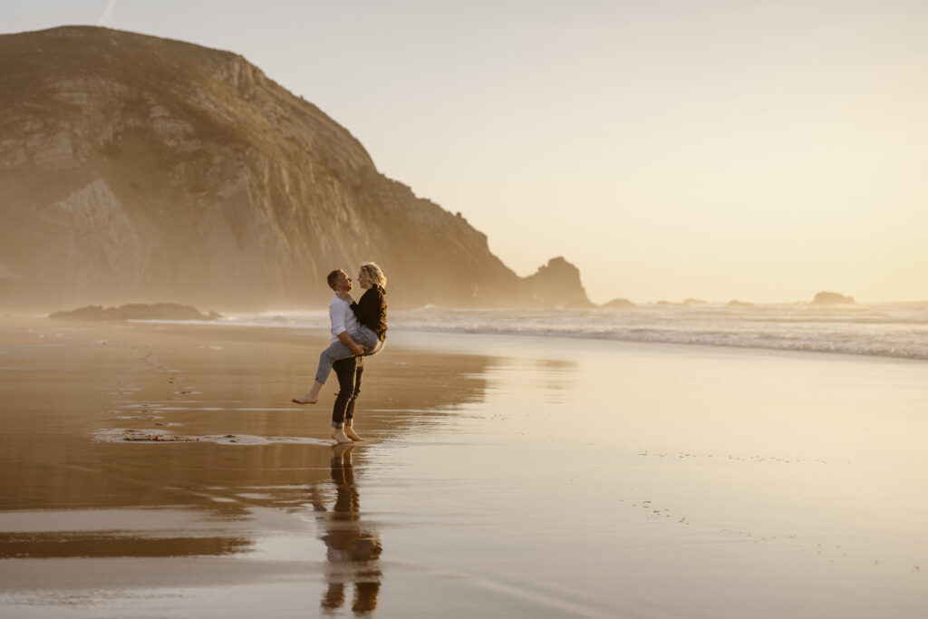 Engaged couple embracing on the beach