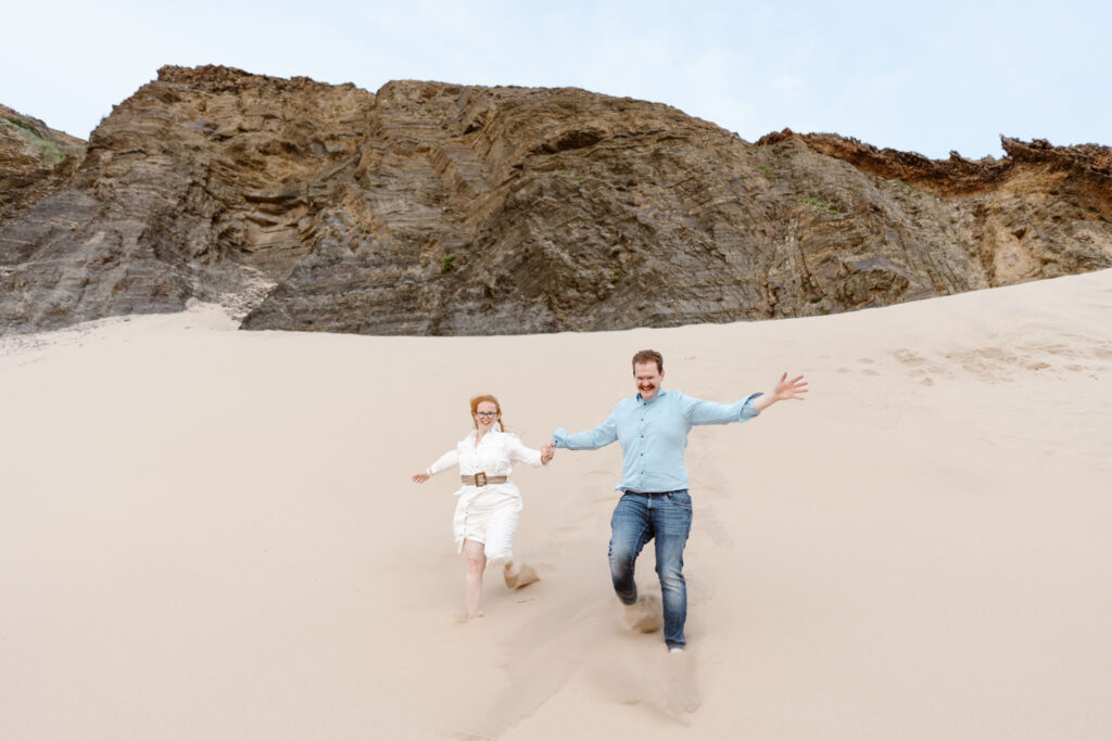 Couple running on the beach together