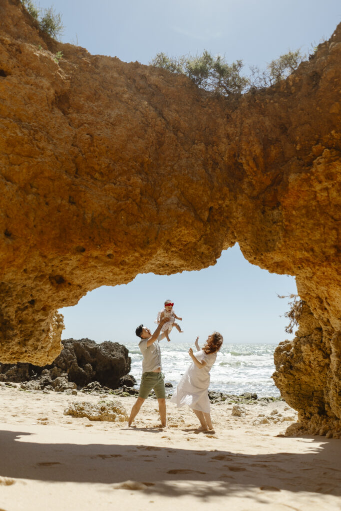 happy family with baby on arrifes beach