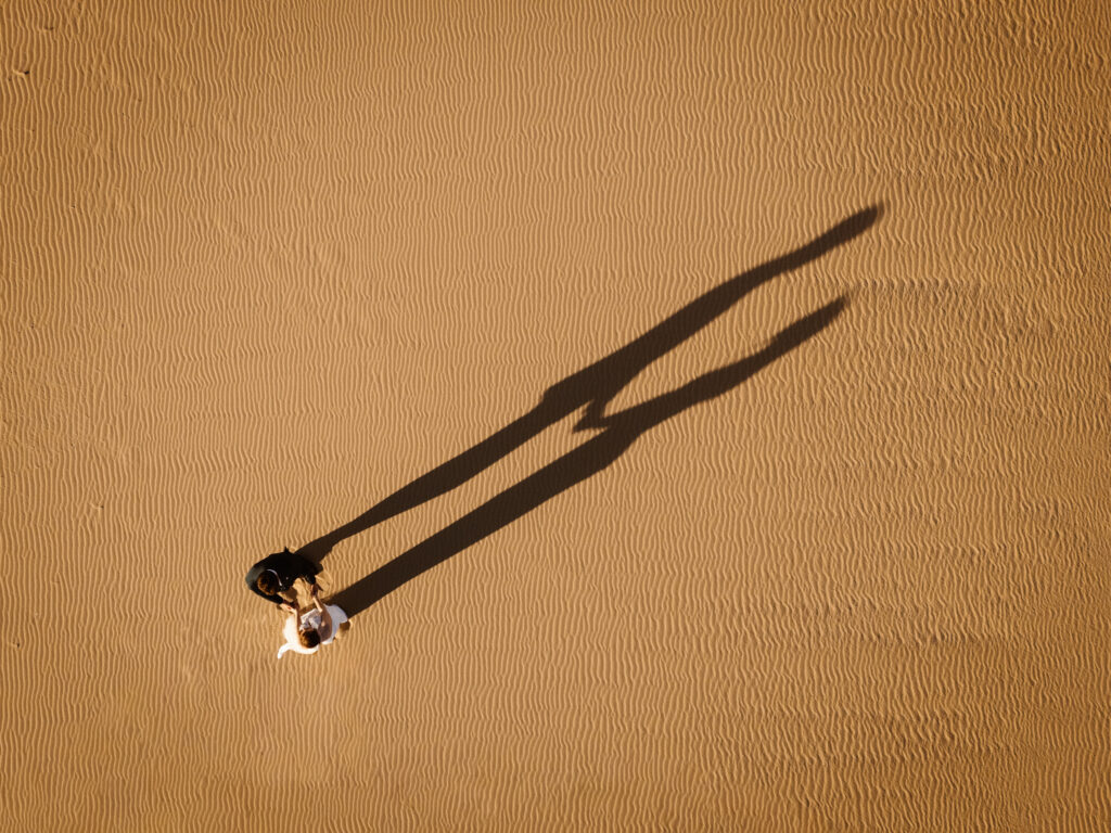 A couple with their shadow on the beach