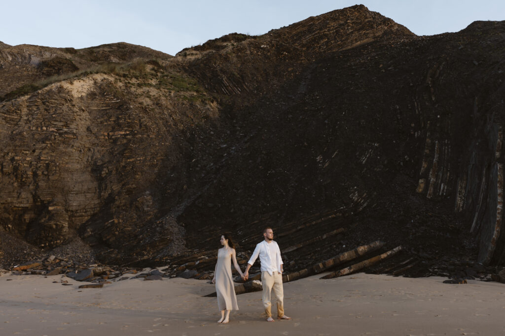 A couple holding hands at the beach