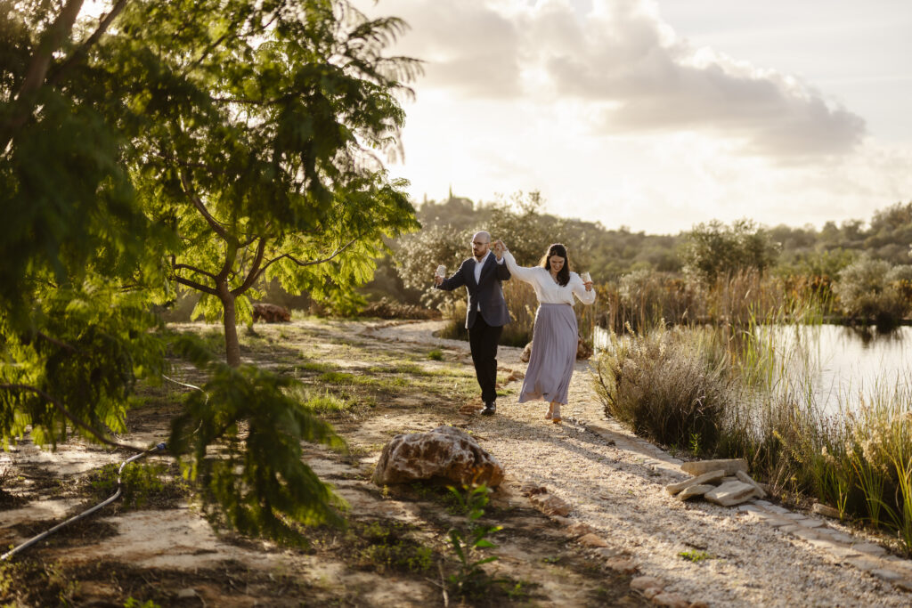 Engagement photoshoot in vinyard. Happy couple in love showing joy and dancing