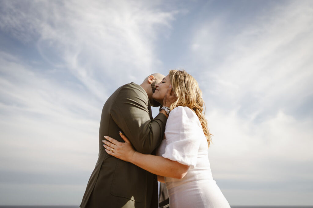 Groom kisses brides neck in Alvor, Portugal