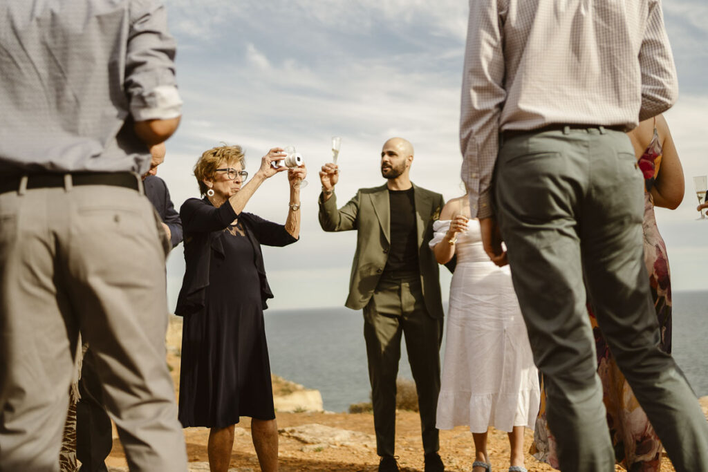 Groom raises a toast in Alvor, Portugal
