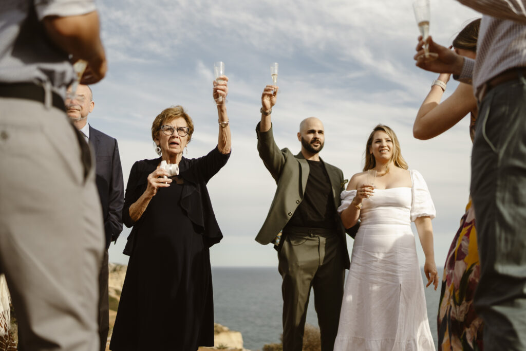 Bride and groom raise a toast in Alvor, Portugal