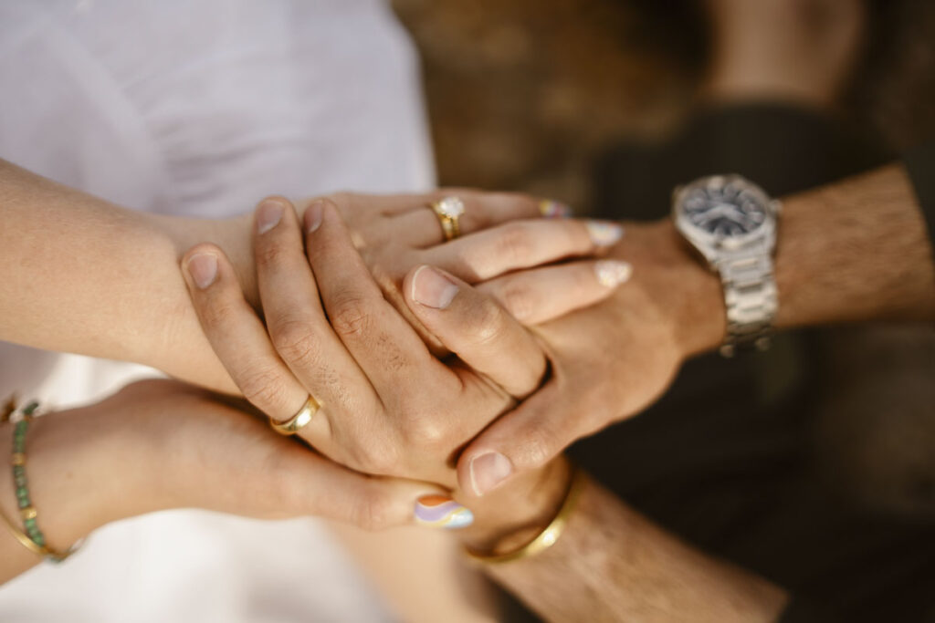 Bride, Groom and friends hold hands in Alvor, Portugal