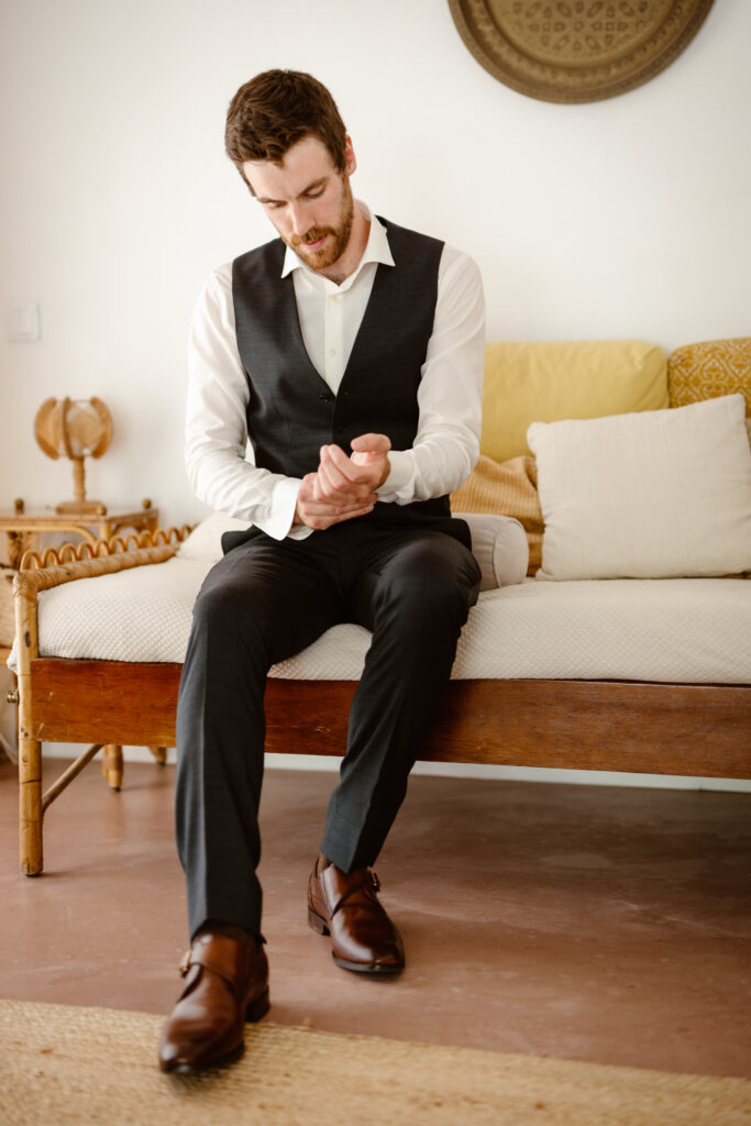 Groom adjusting his cuffs in Loule, Portugal