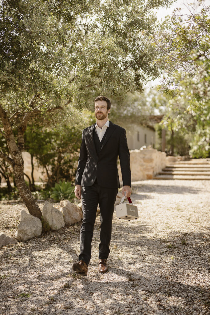 Groom walking with an amp in Loule, Portugal