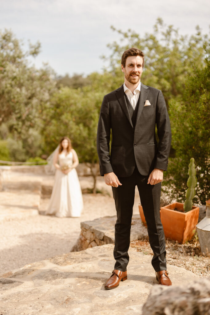 Groom with bride in background in Loule, Portugal