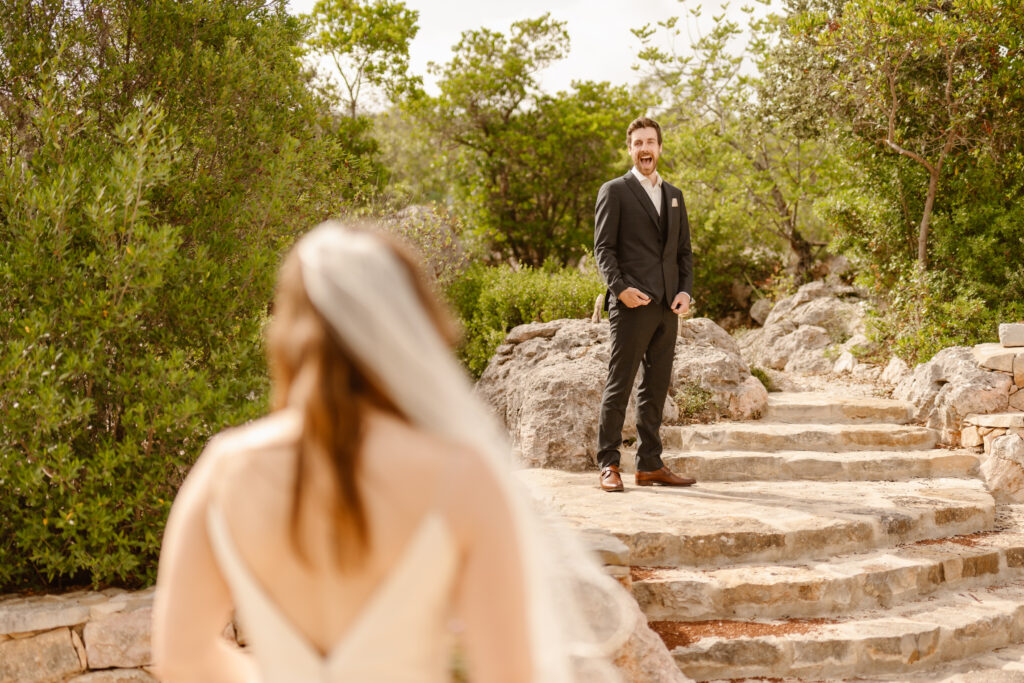 Groom smiles at bride in Loule, Portugal