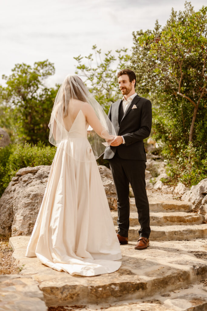 Groom watches bride in Loule, Portugal