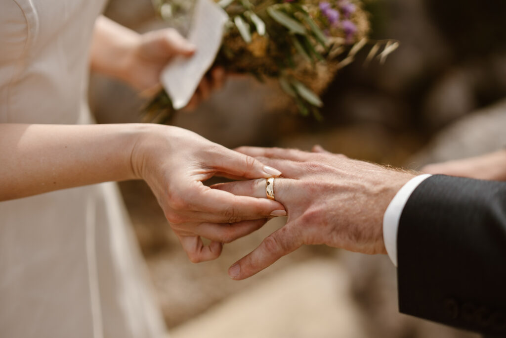 Bride puts ring on groom in Loule, Portugal