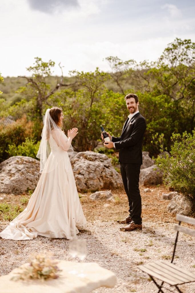Bride and groom holding champagne in Loule, Portugal