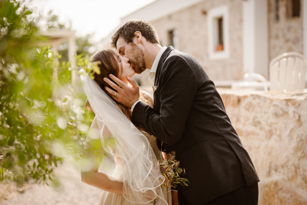 Groom kisses bride in Loule, Portugal