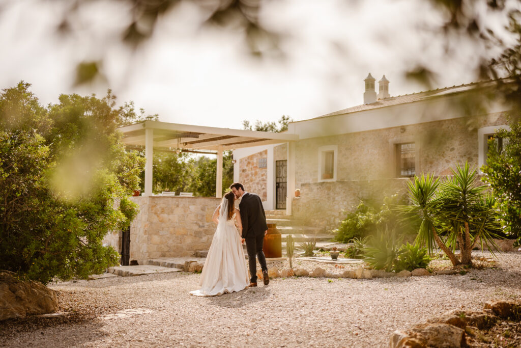 Groom kisses bride in Loule, Portugal