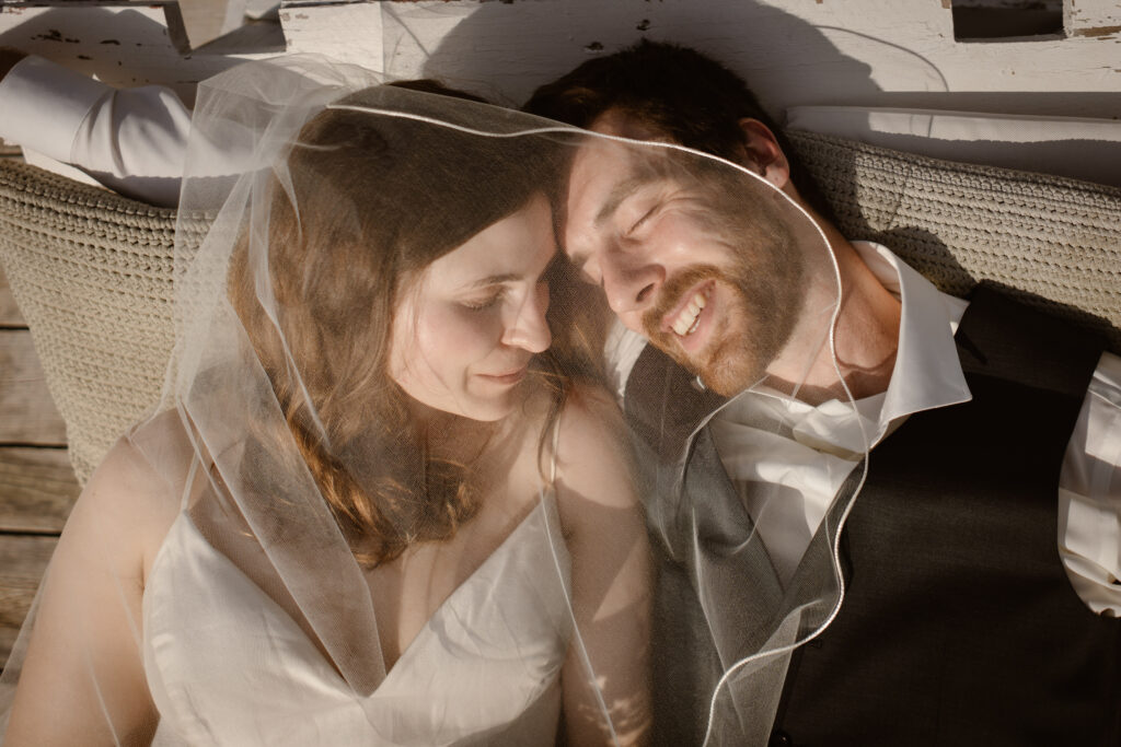 Bride and groom under veil in Loule, Portugal