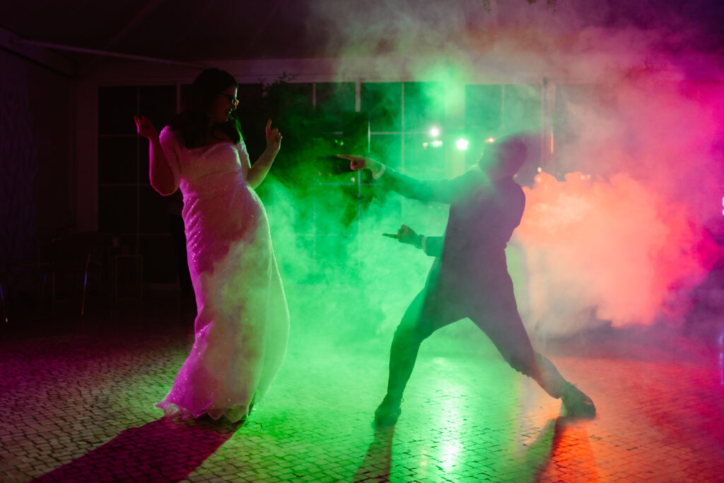 Bride and groom first dance in colorful smoke