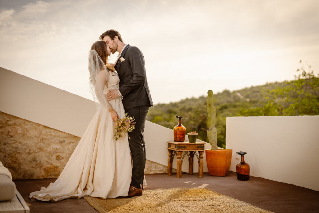 Groom kisses bride in Loule, Portugal
