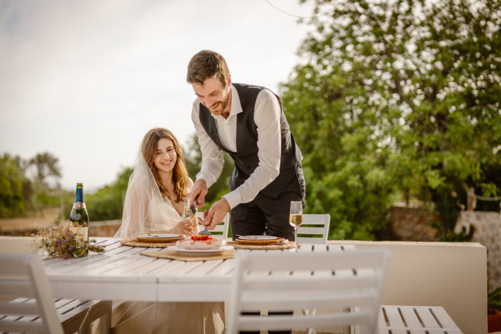 Groom cuts cake in Loule, Portugal