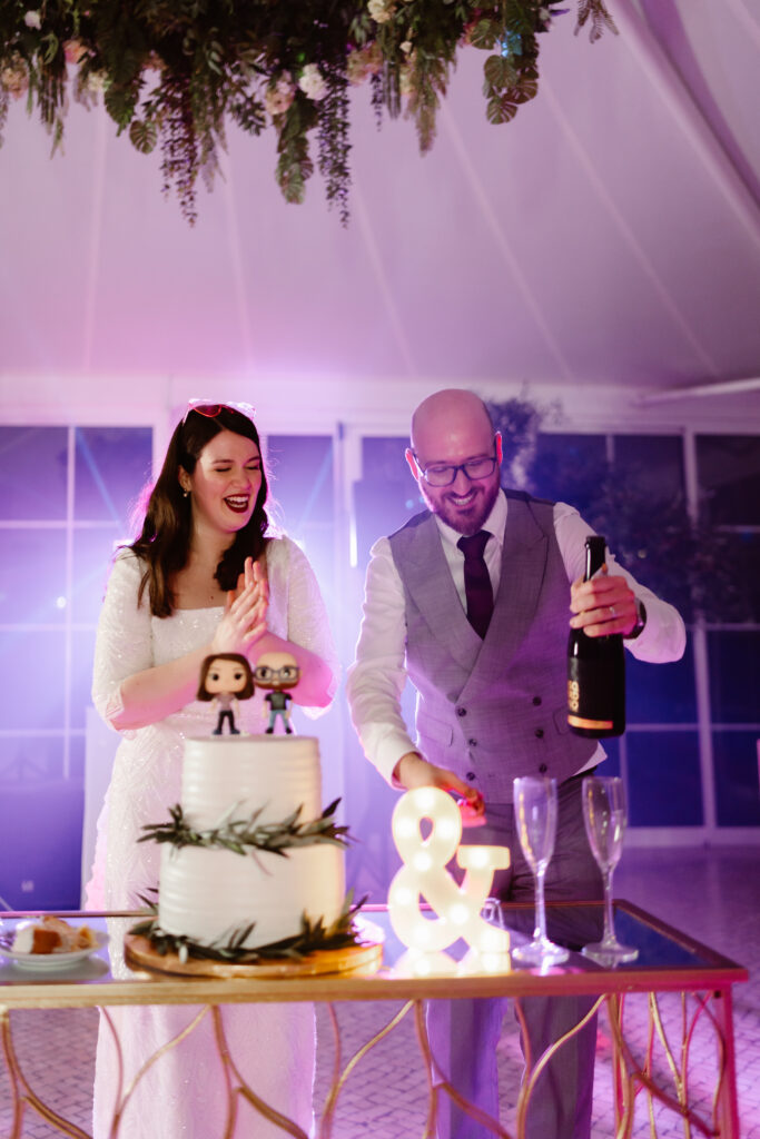 bride and groom with champagne and wedding cake algarve