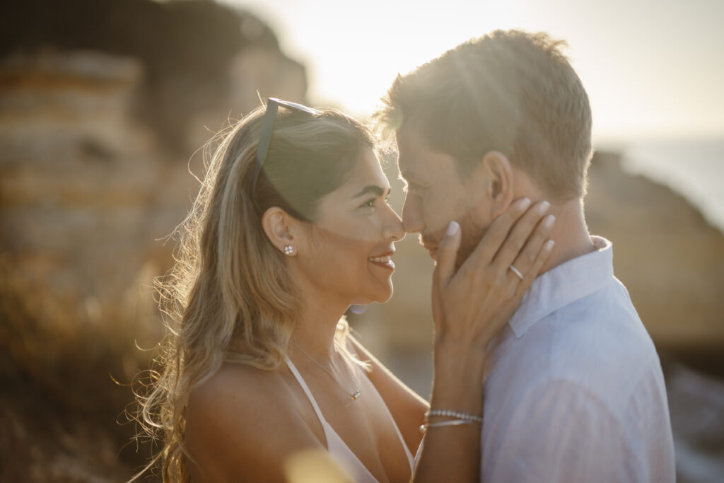 Woman holds fiancés face in her hands