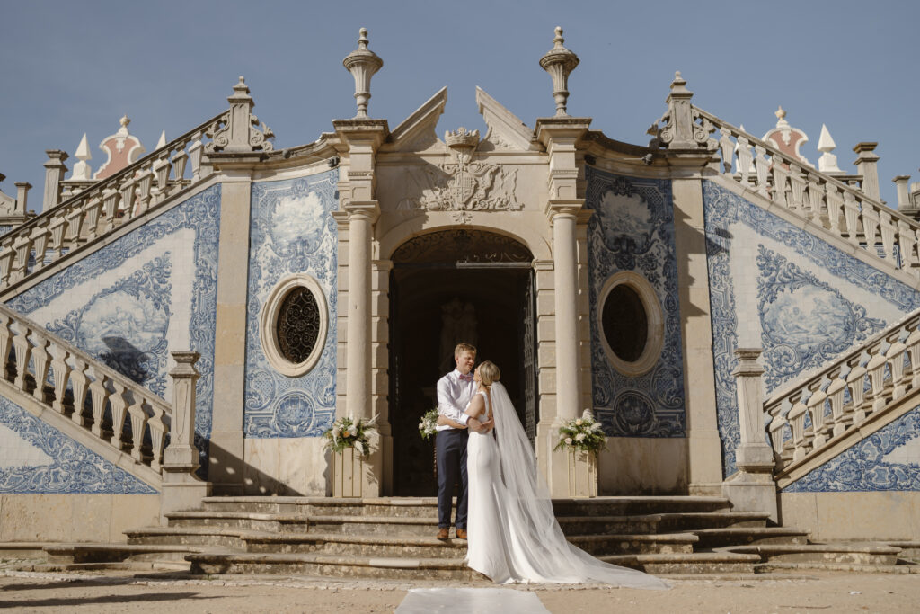 Couple standing in front of blue-patterned entrance
