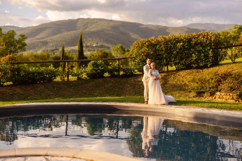 The bride and groom by the pond. Elopement in Tuscany.