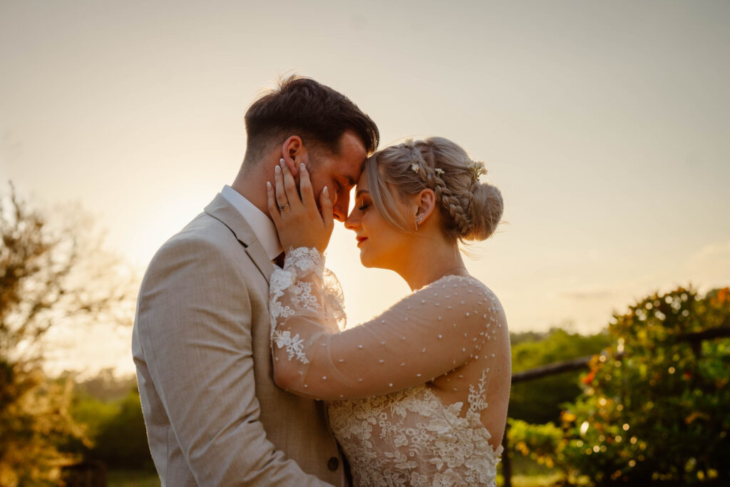 The bride tenderly embraces the face of her groom. Elopement in Italy.