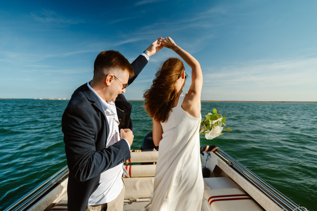 Dancing bride and groom in the boat . Elopement in Portugal.