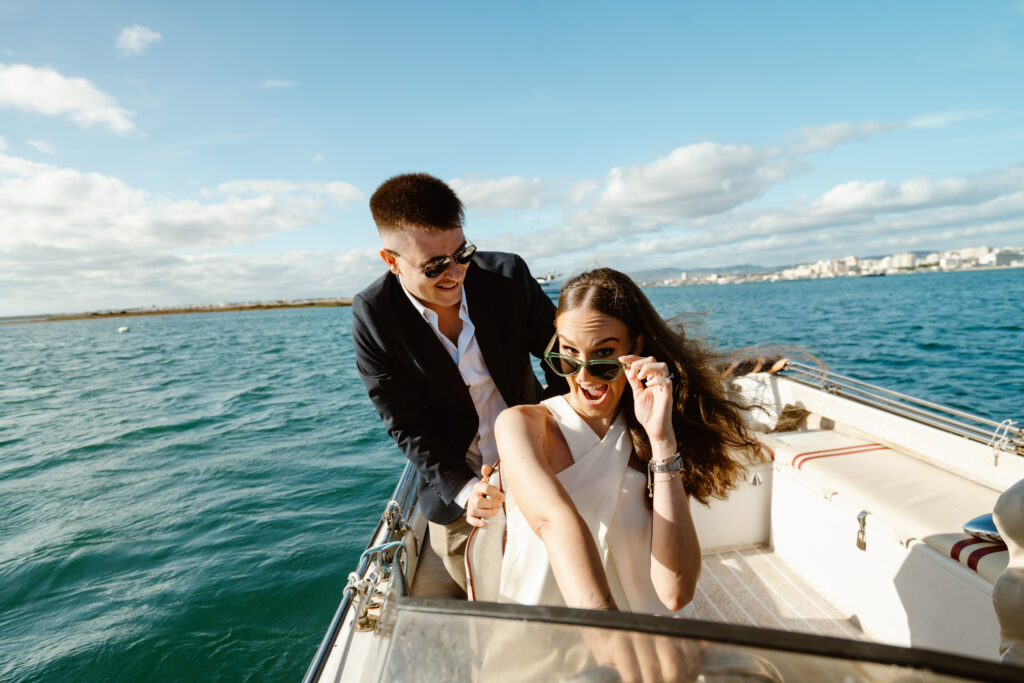 Bride and groom on the boat in Faro. Elopement wedding photo session in Algarve.