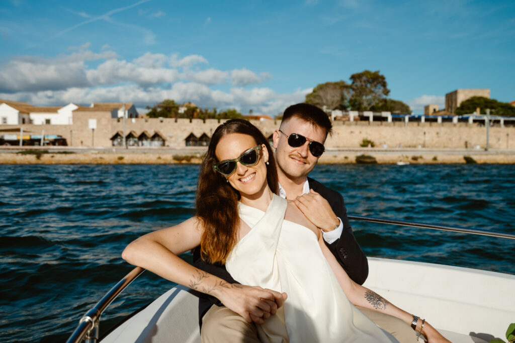 Bride and groom on the boat with Faro old town in the background