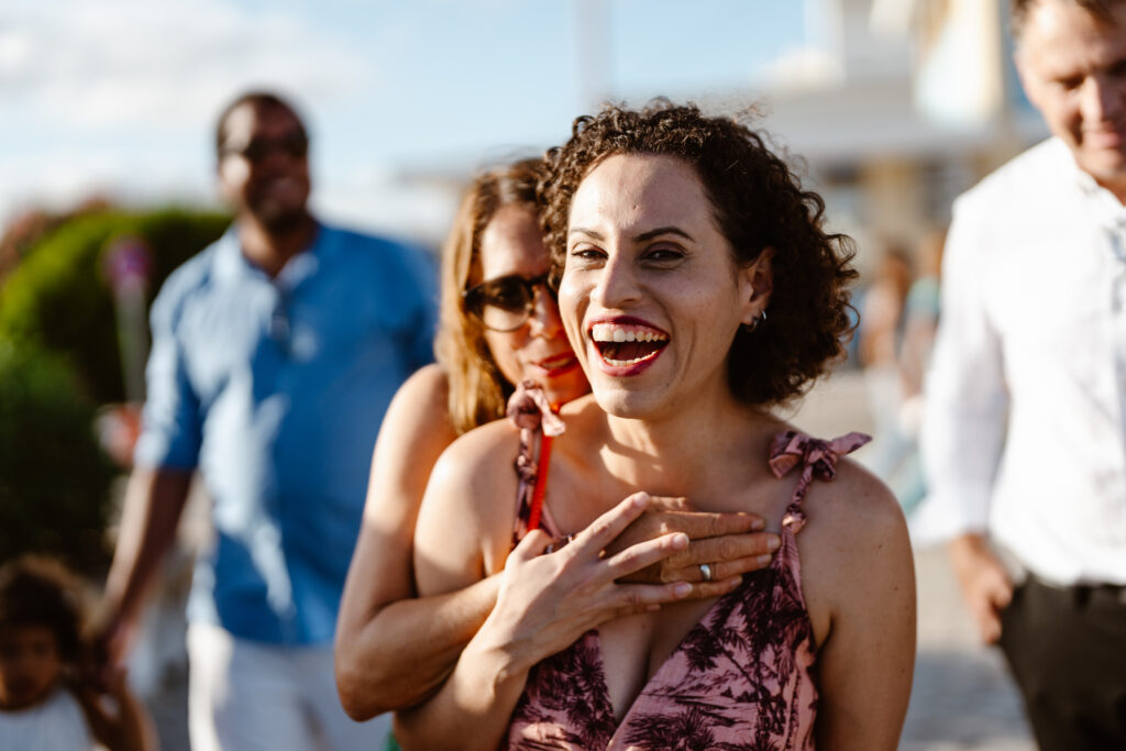 Wedding guest laughs happily in Algarve, Portugal
