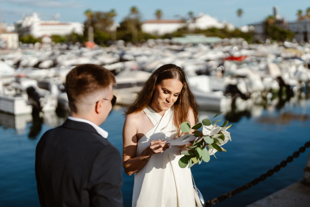 Bride reads vows next to her groom in Algarve, Portugal
