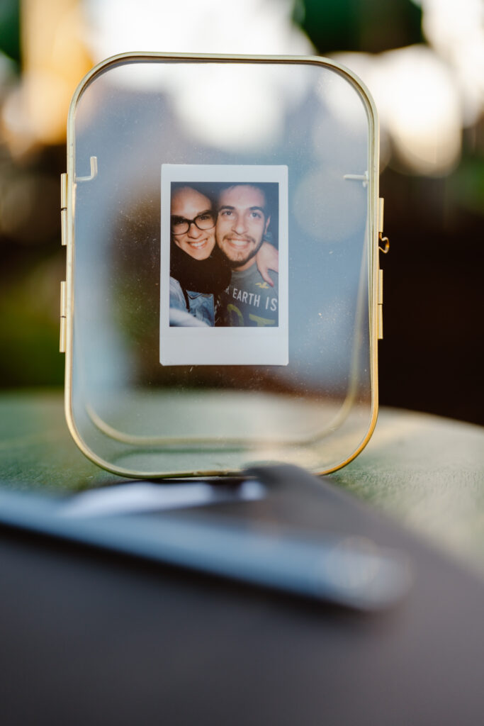 A polaroid of the married couple in a glass container in Algarve, Portugal