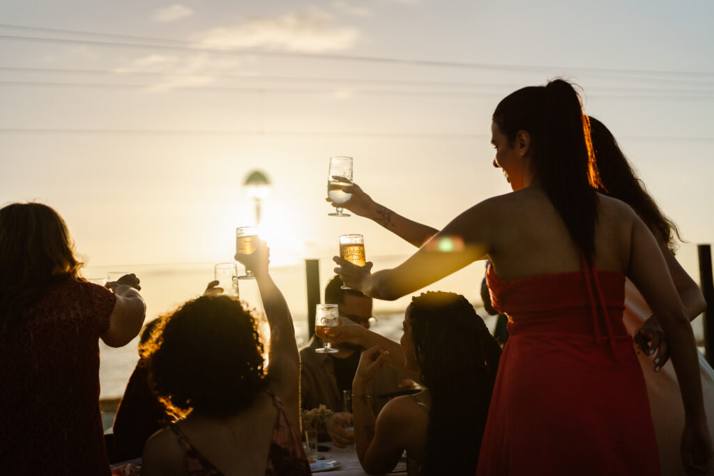 Guests clink glasses at wedding in Algarve, Portugal