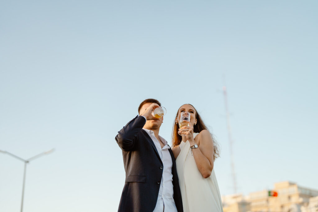 Bride and groom drink together in Algarve, Portugal