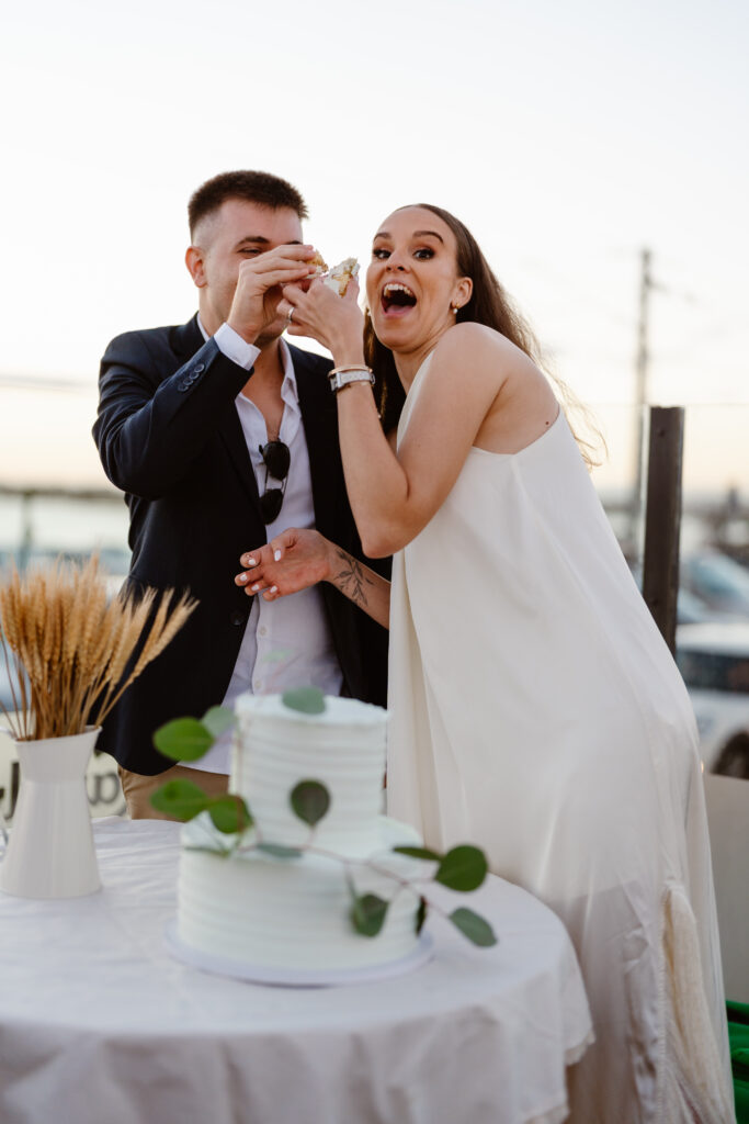 Bride and groom tasting the first piece of wedding cake