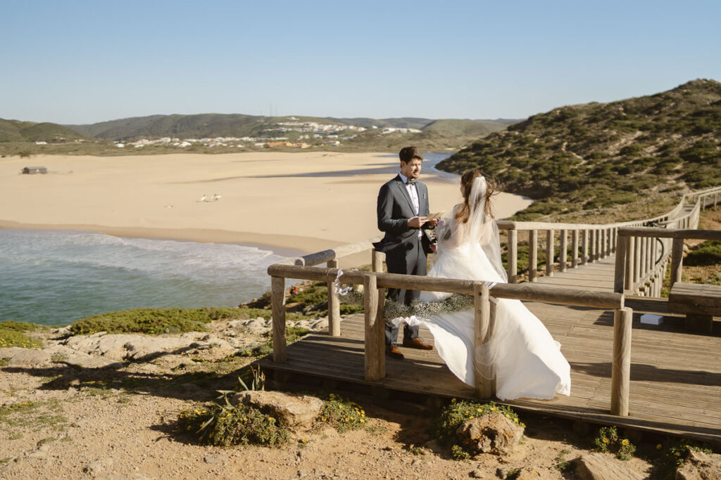 Groom reads vows in Bordeira, Portugal