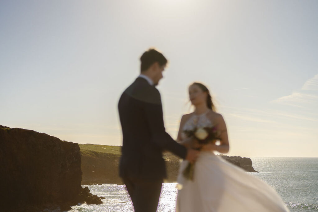 Blurred shot of bride and groom in Bordeira, Portugal
