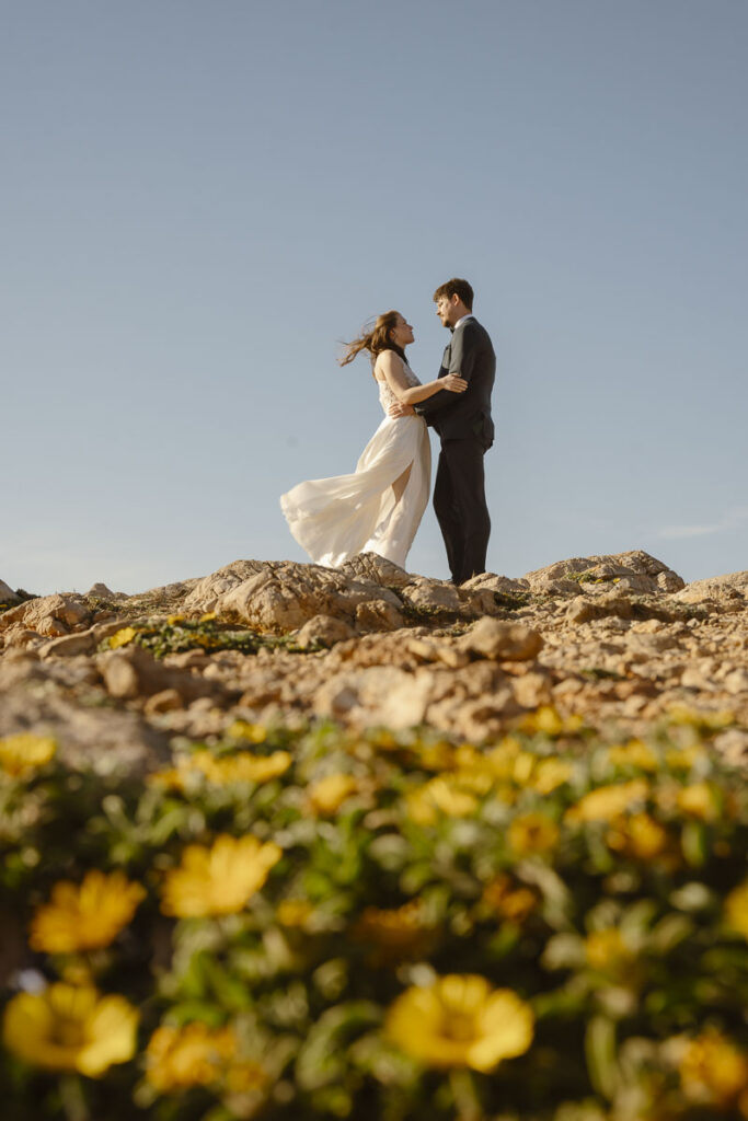 Bride and groom facing each other in Bordeira, Portugal