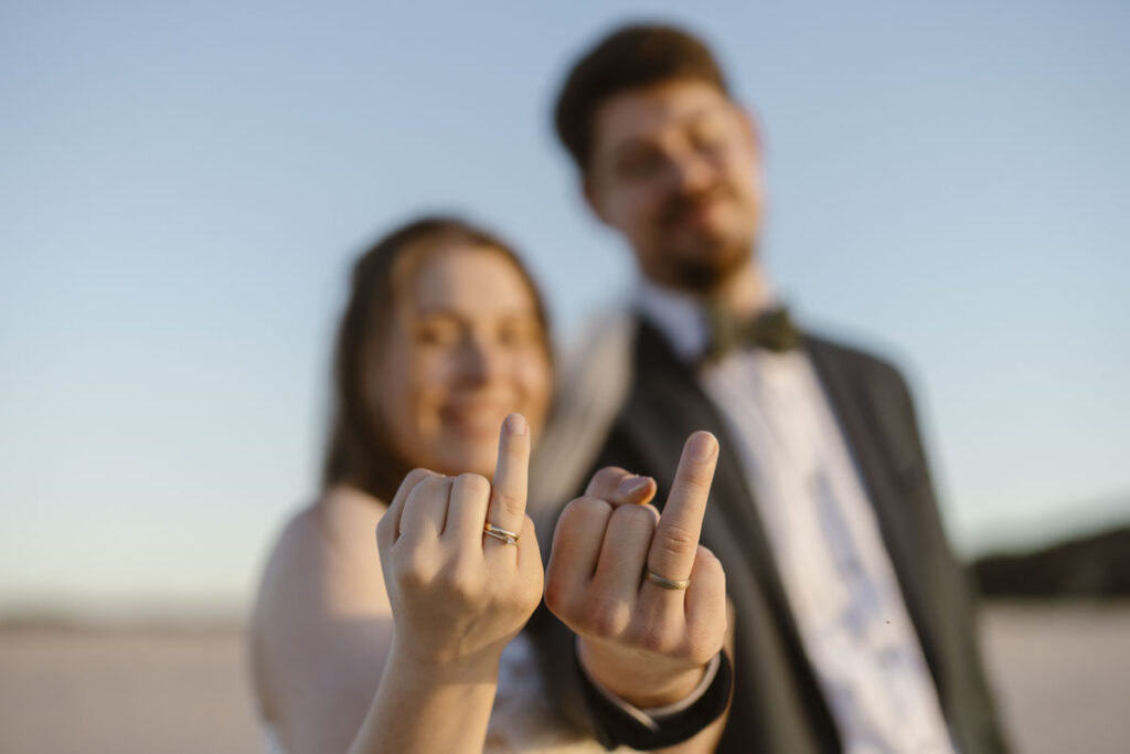 Bride and groom ring fingers in Bordeira, Portugal