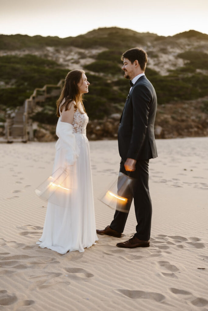 Bride and groom on beach in Bordeira, Portugal