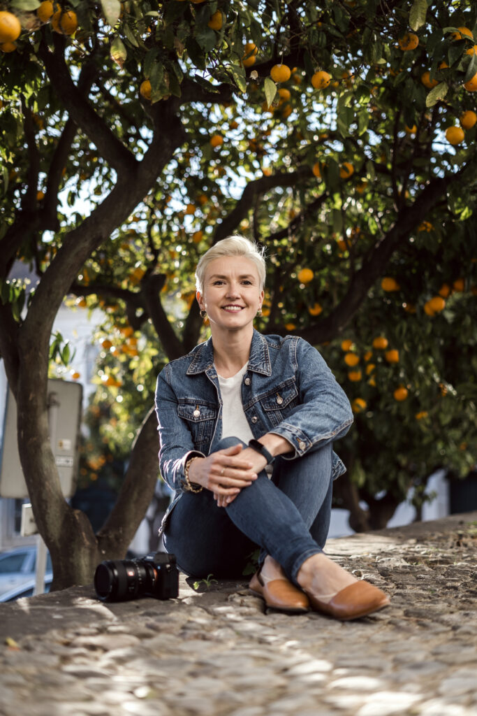 A woman sitting in front of lemon trees