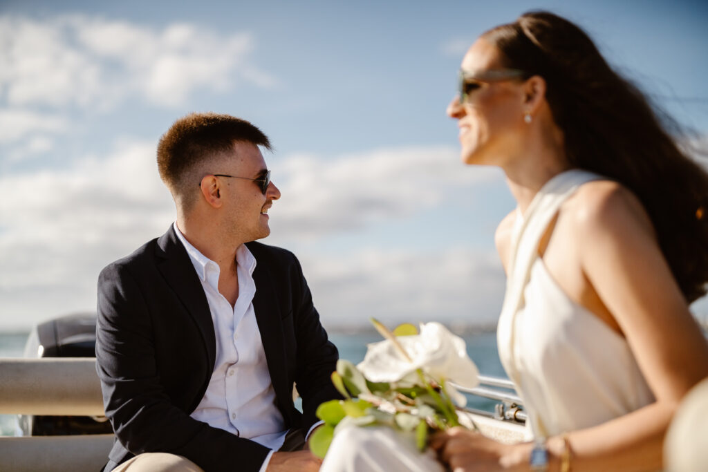 Bride and groom sit in a speedboat in Algarve, Portugal