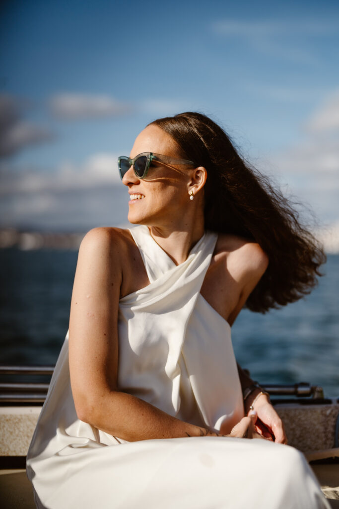 Bride sits on speedboat in Algarve, Portugal