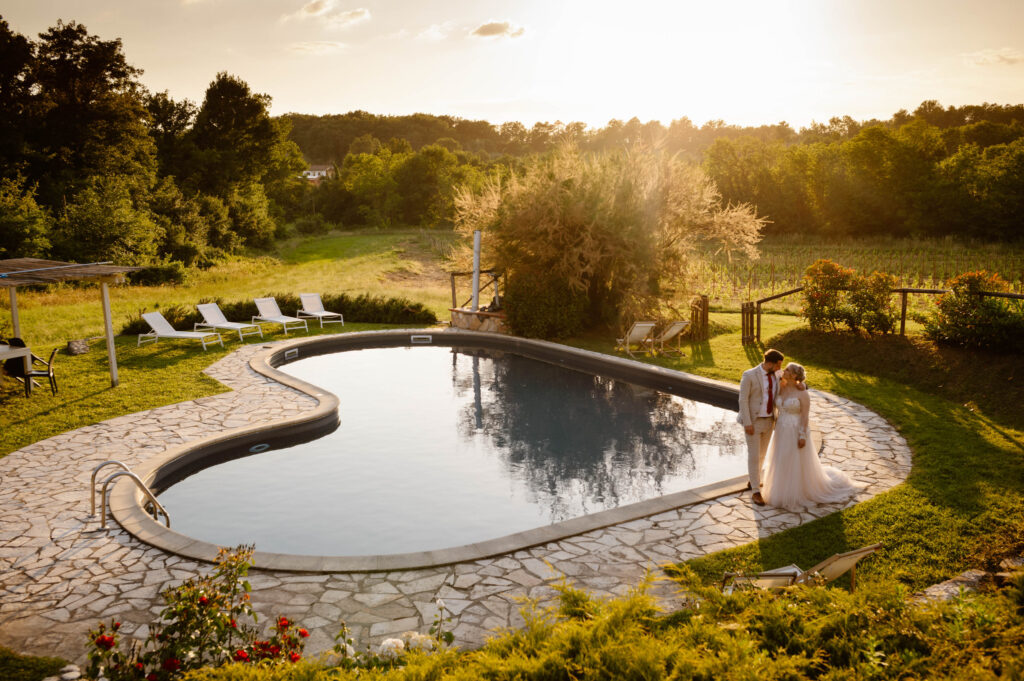 A couple standing in front of a heart shaped pool